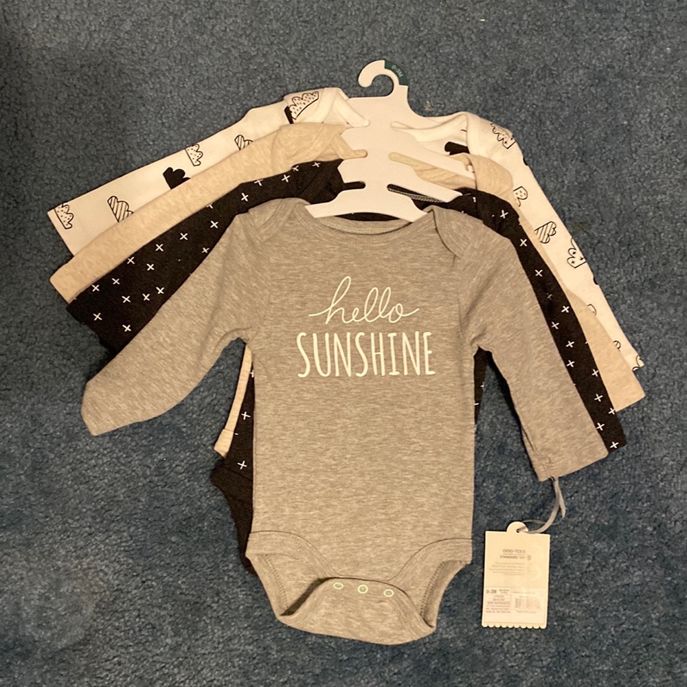 Four pack long sleeve onesies. New with tags. Cloud island brand.0-3 months